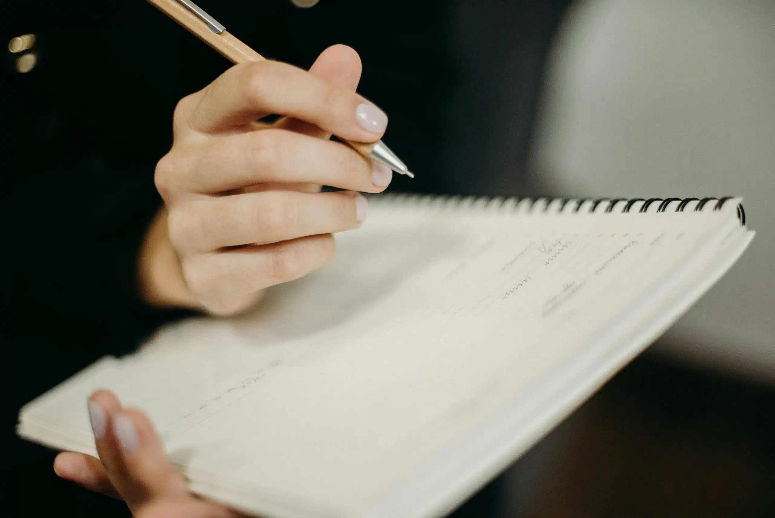 Author writing in a book
